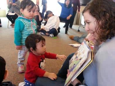 At a TRC Mother's Day event, a volunteer reads, "Are You My Mother?"