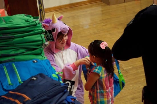 Riley Gantt, pitching in at a Rainbow Pack backpack giveaway (courtesy).
