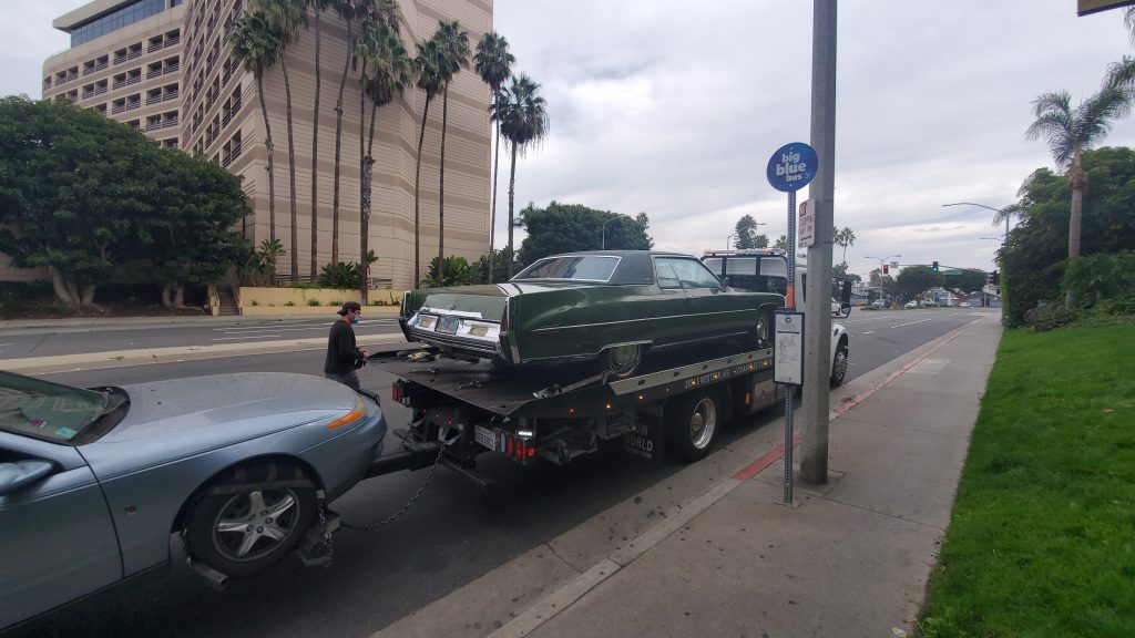 Cadillac Deville is towed away