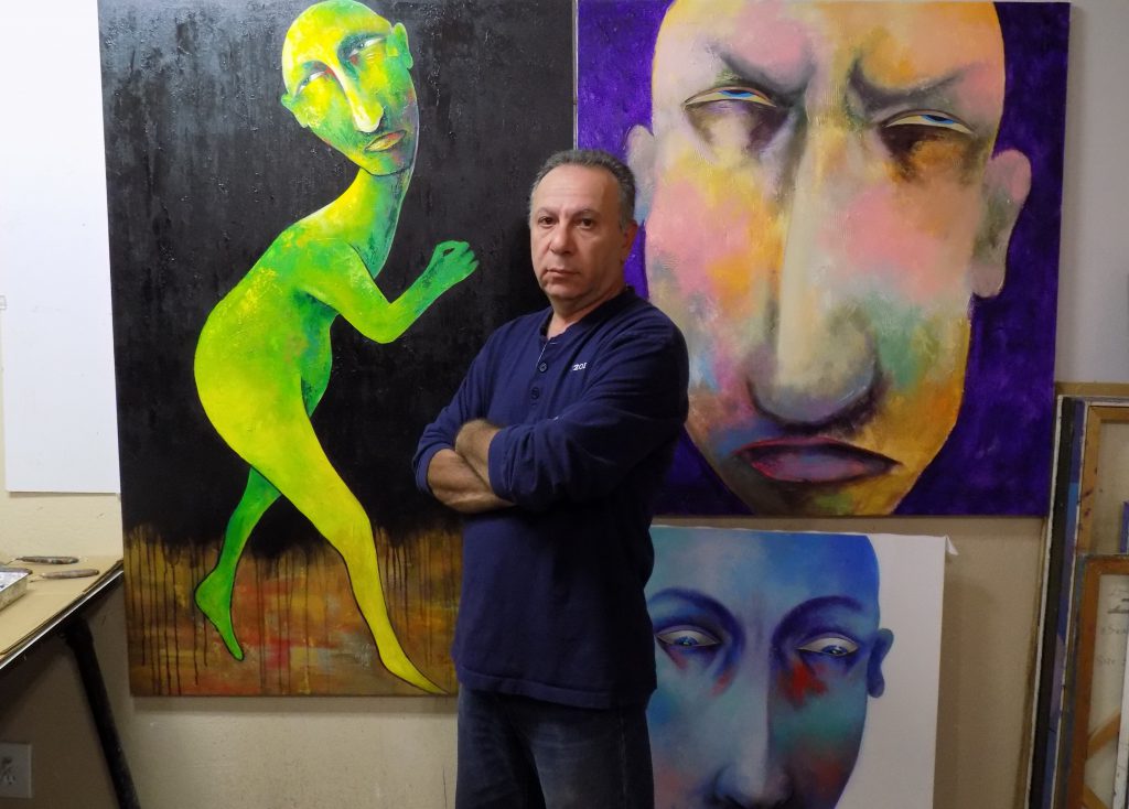 Artist Ara (Arbe) Berberyan with his paintings