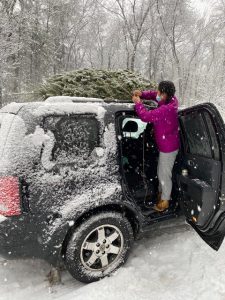 Hannah tying christmas tree