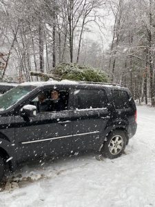 Son Luke drives the Christmas tree home in the donated Honda