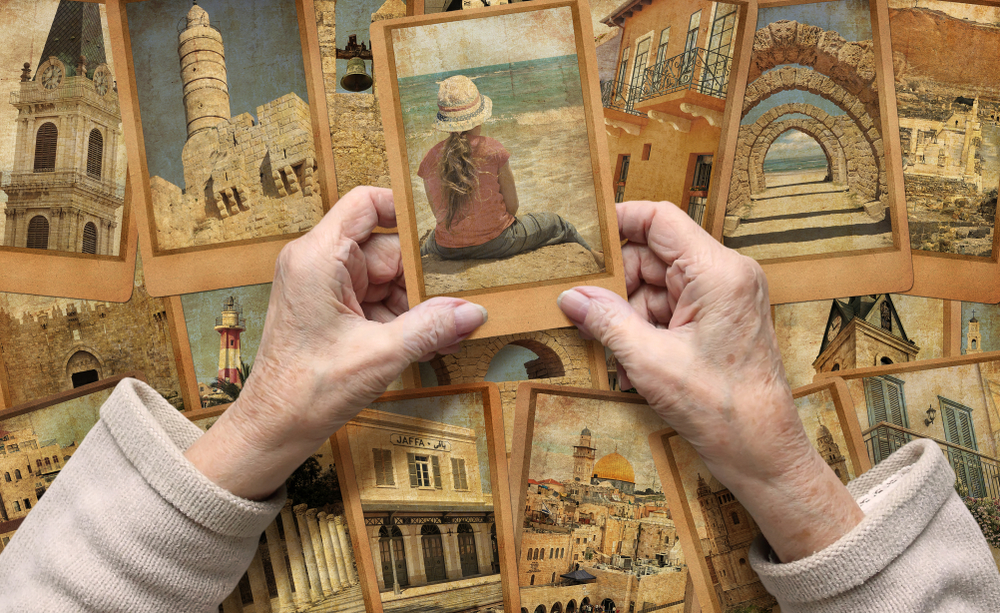 Old woman holds looks photo of loved one who has passed