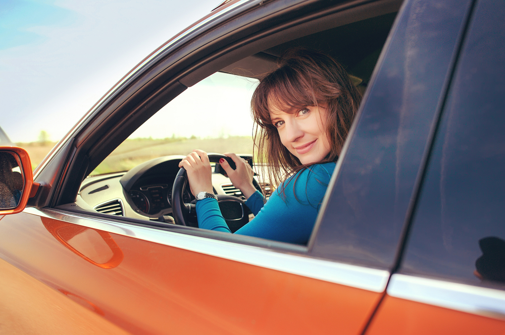 orange car female driver at wheel