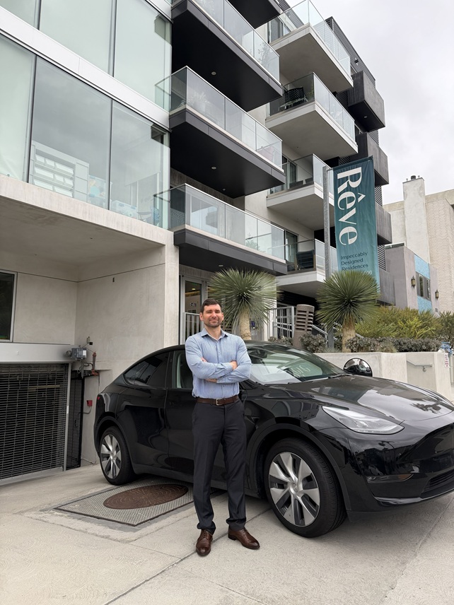 Michael Ouziel lawyer with his Tesla