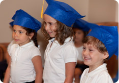 Children wearing graduation caps in a Kars4Kids sponsored preschool 
