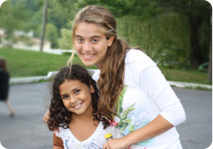 A female counselor smiles with her camper in TheZone summer camp
